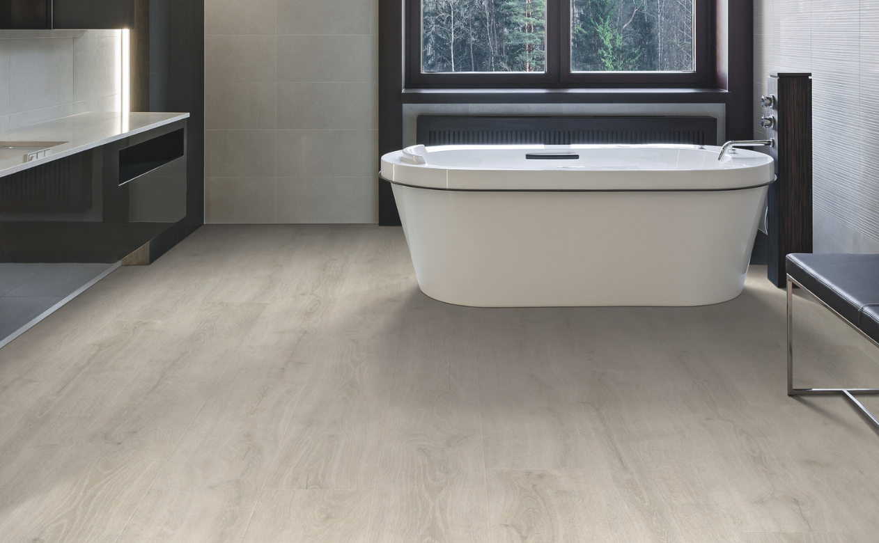bathroom with laminate flooring and freestanding tub